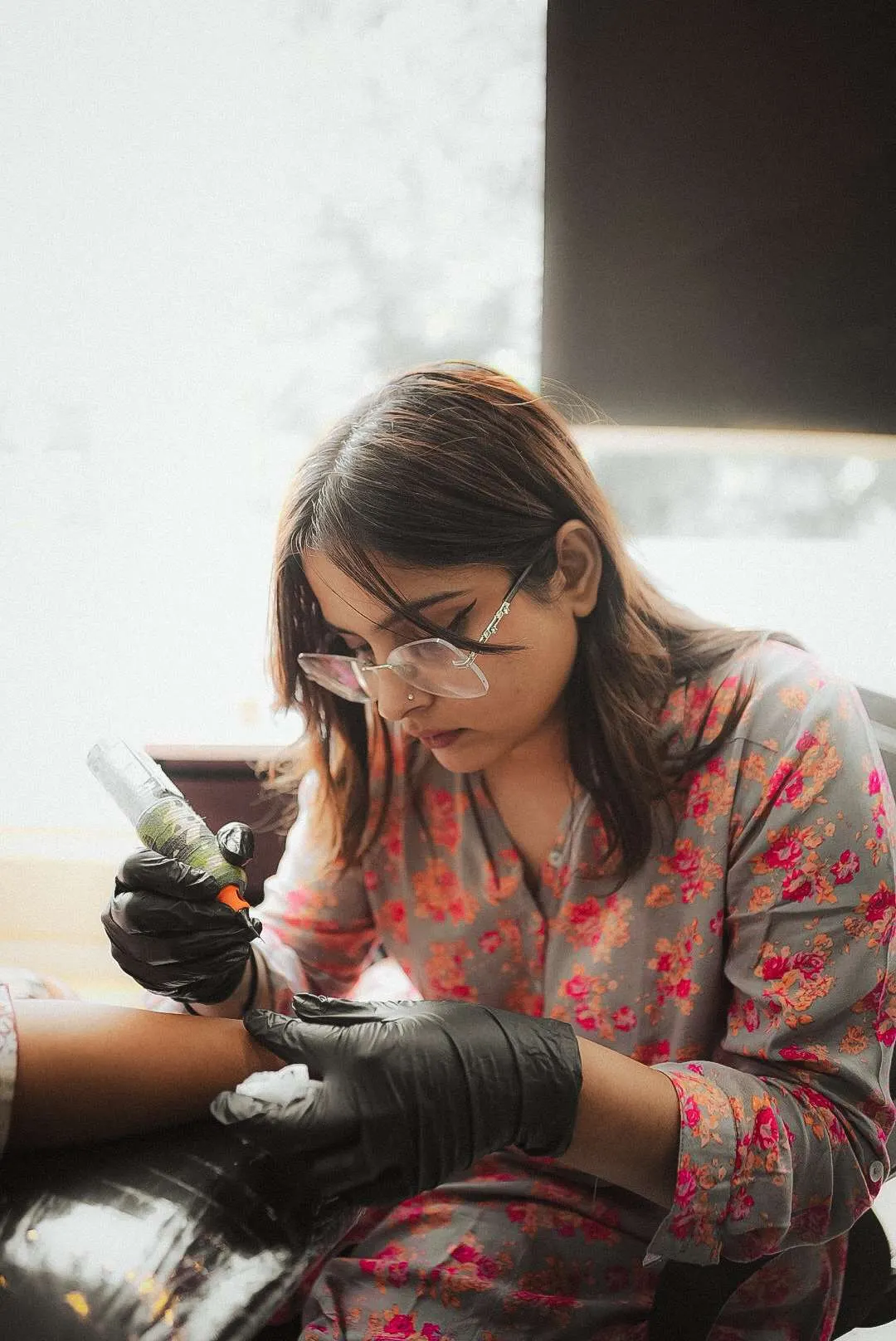 Divinya, head tattoo artist at Kamz Inkzone
